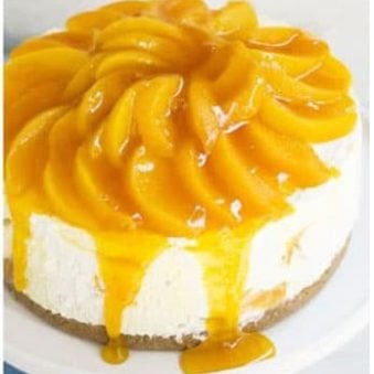 Best Easy No Bake Peach Cheesecake on White Cake Stand.