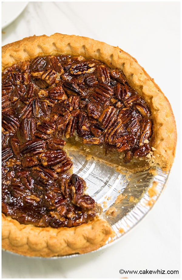 Easy Pecan Pie With One Slice Removed on White Background
