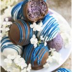 Stack of Easy Healthy Chocolate Blueberry Truffles on White Dish With Flowers.