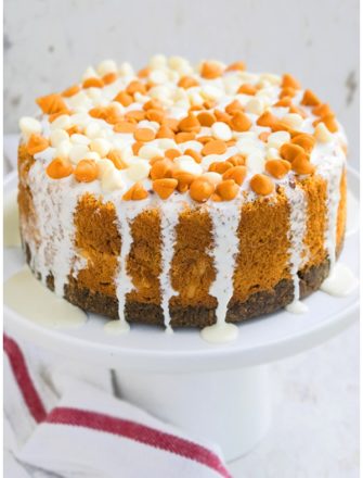 Easy Pumpkin Cheesecake With Gingersnap Crust and White Chocolate Ganache on White Cake Stand