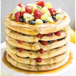 Easy Waffle Cake With Peanut Butter, Maple Syrup and Fresh Fruits on White Cake Stand.