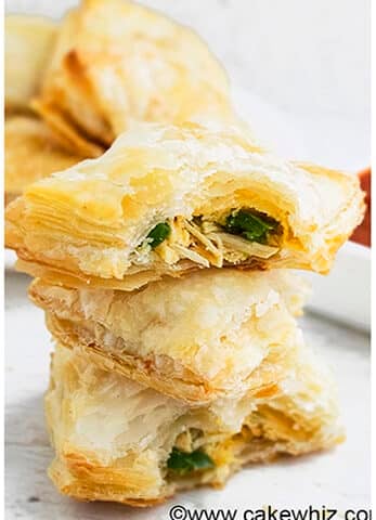 Stack of Easy Jalapeno Chicken Puff Pastry With One Partially Eaten.