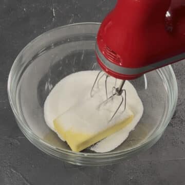 Butter and sugar in glass bowl ready to be mixed. 
