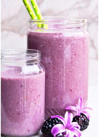 Easy Blackberry Smoothie in Glass Jars With Marble Background.