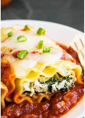 Easy Spinach Lasagna Rolls on White Dish.