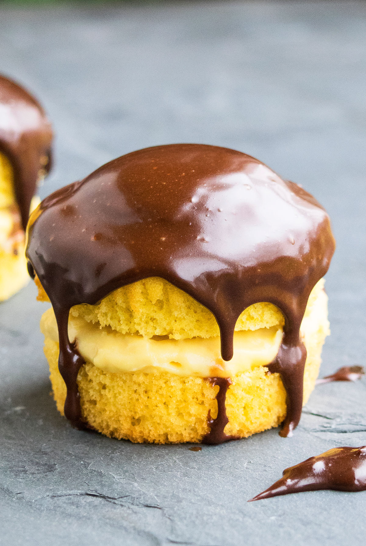 Closeup Shot of Easy Boston Cream Cupcakes With Cake Mix Box on Gray Background. 