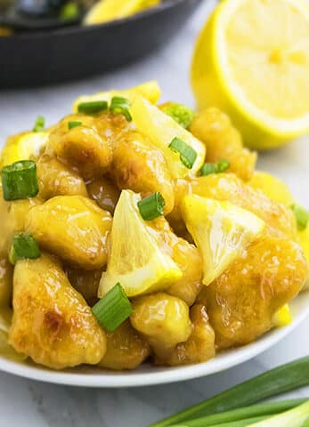Best Easy Chinese Lemon Chicken on White Dish With Marble Background.