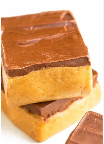 Stack of Easy No Bake Peanut Butter Bars With Chocolate Topping on Marble Background.