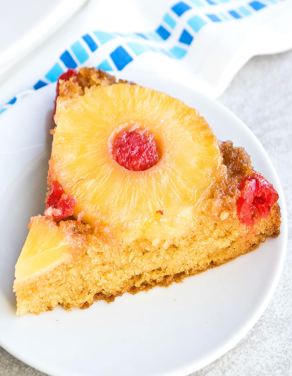 Slice of Upside Down Cake on White Dish. 