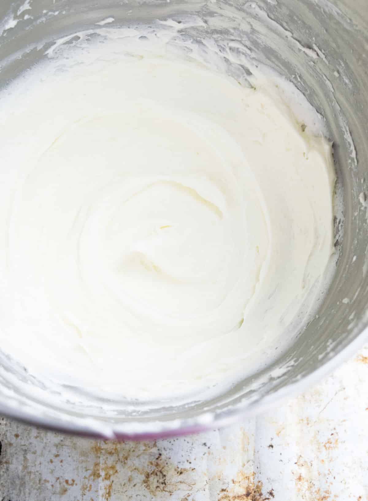 Fluffy white topping in stainless steel bowl.  