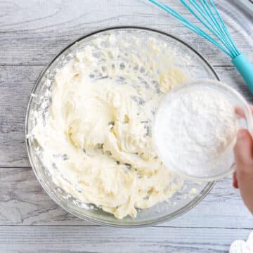 Powdered sugar and other dry ingredients being added to mixture. 