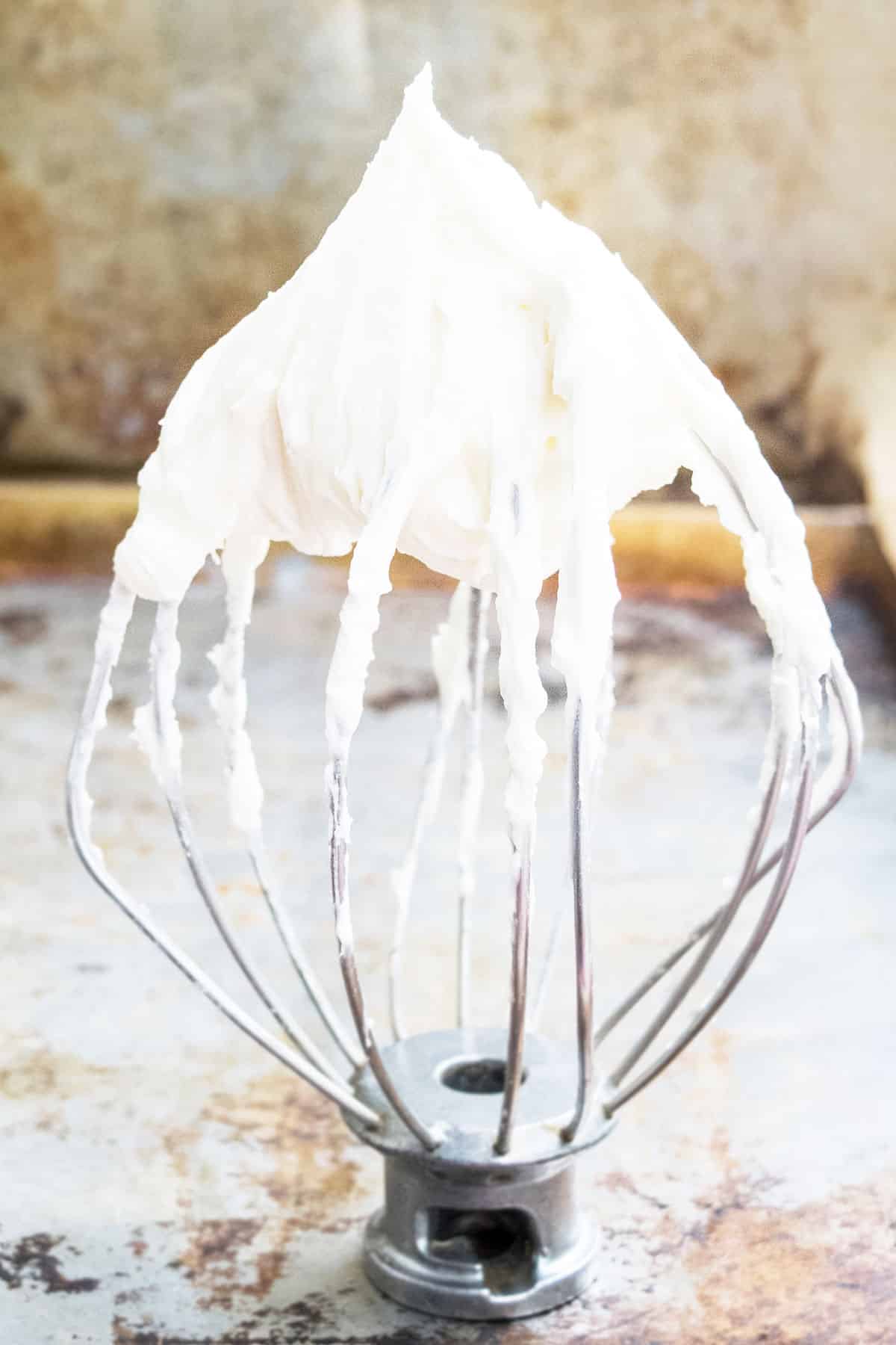 Easy Cream Cheese Frosting on Whisk for Piping and Cake Decorating. 