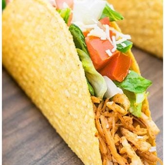 Easy Shredded Chicken Tacos on Wood Background.