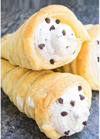 Stack of Best Easy Cream Horns With Puff Pastry on Rustic Gray Background.