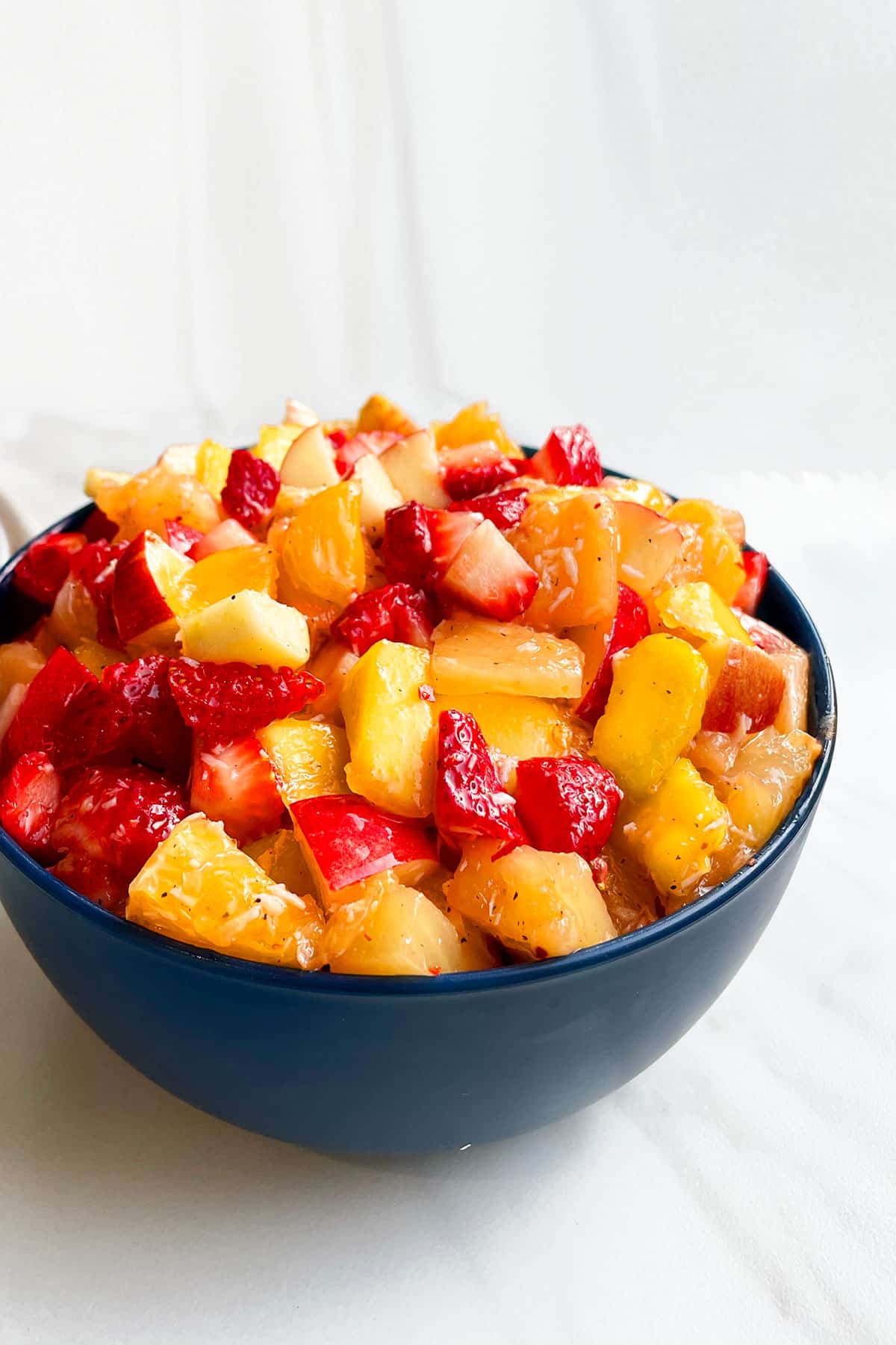 Easy Fruit Salad With Honey Lime Dressing in Blue Bowl.
