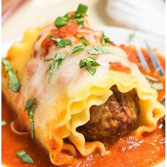 Meatball Lasagna Roll Ups on White Dish.