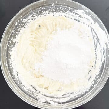 Powdered sugar added to other ingredients in glass bowl.  