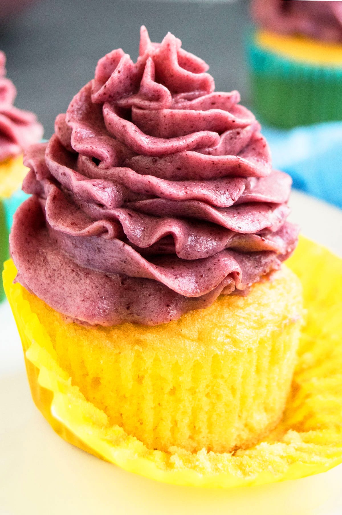 Easy fresh blackberry buttercream frosting piped on top of vanilla cupcake. 