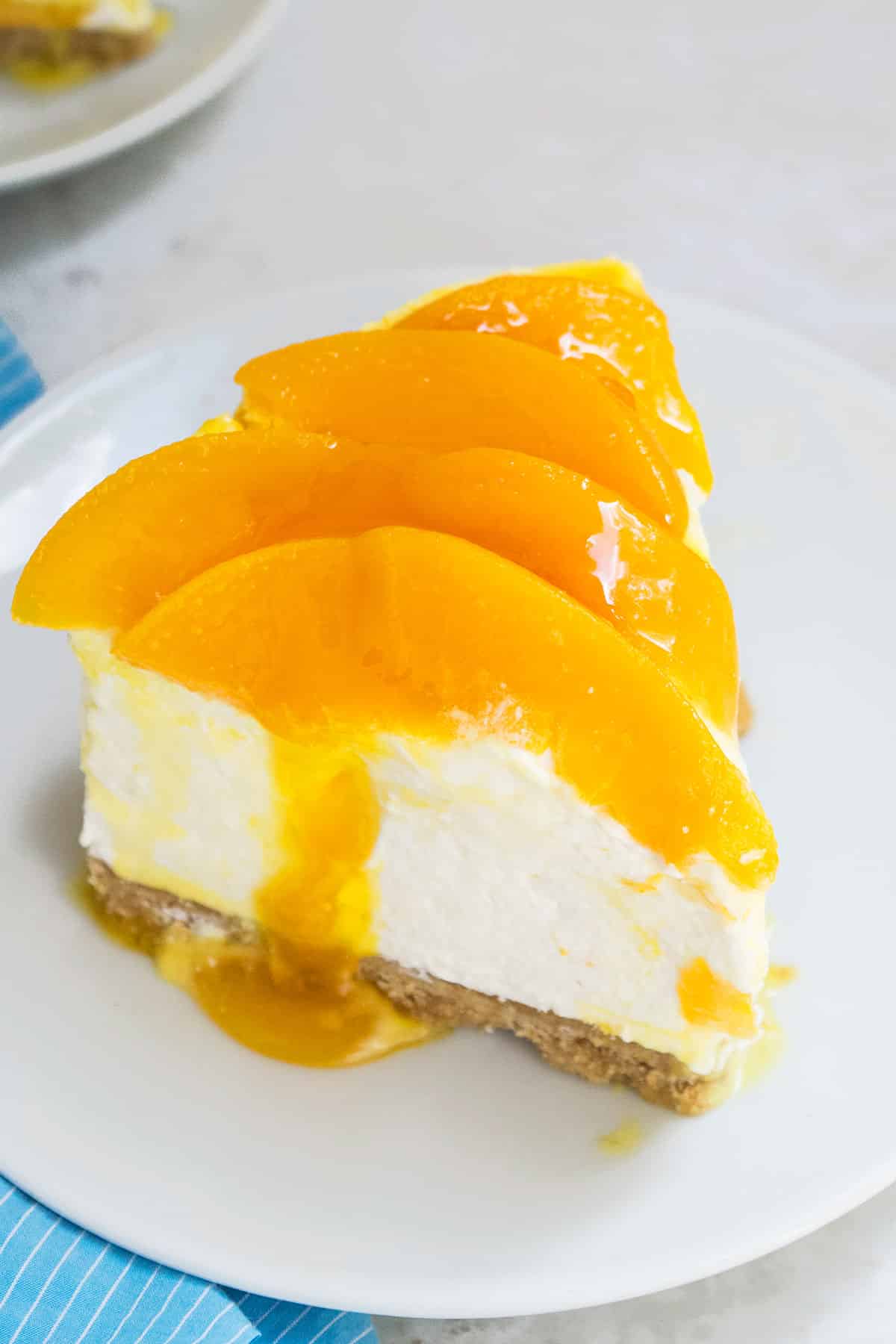 Slice of cheesecake of white dish. 