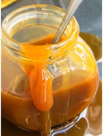 Easy Homemade Caramel Sauce in Glass Jar on Gray Background