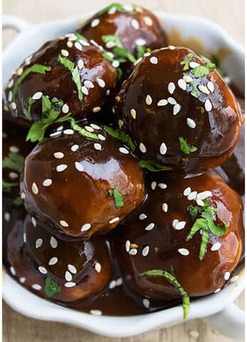 Stack of Easy Sweet and Spicy Korean Meatballs in White Dish.