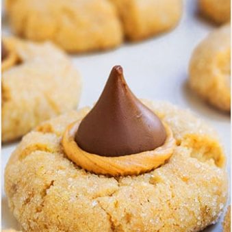 Easy Peanut Butter Blossoms With Hershey's Kisses on White Marble Background.