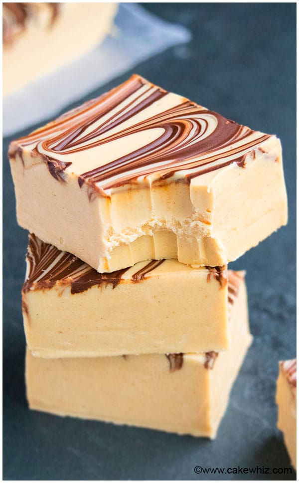 Stack of Peanut Butter Fudge With One That\'s Partially Eaten on Dark Gray Background. 