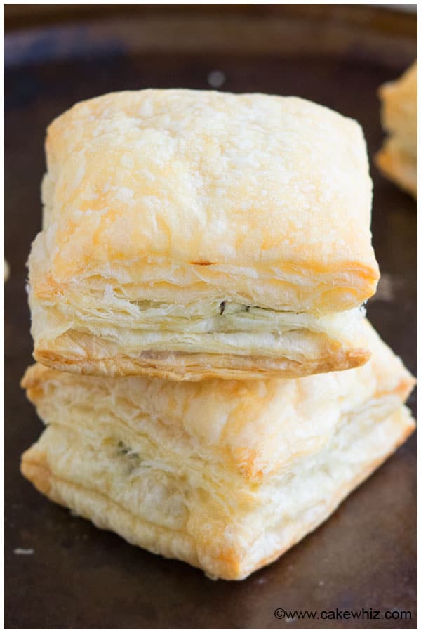 Stack of Vegetarian Spinach Puffs on Dark Metal Tray. 