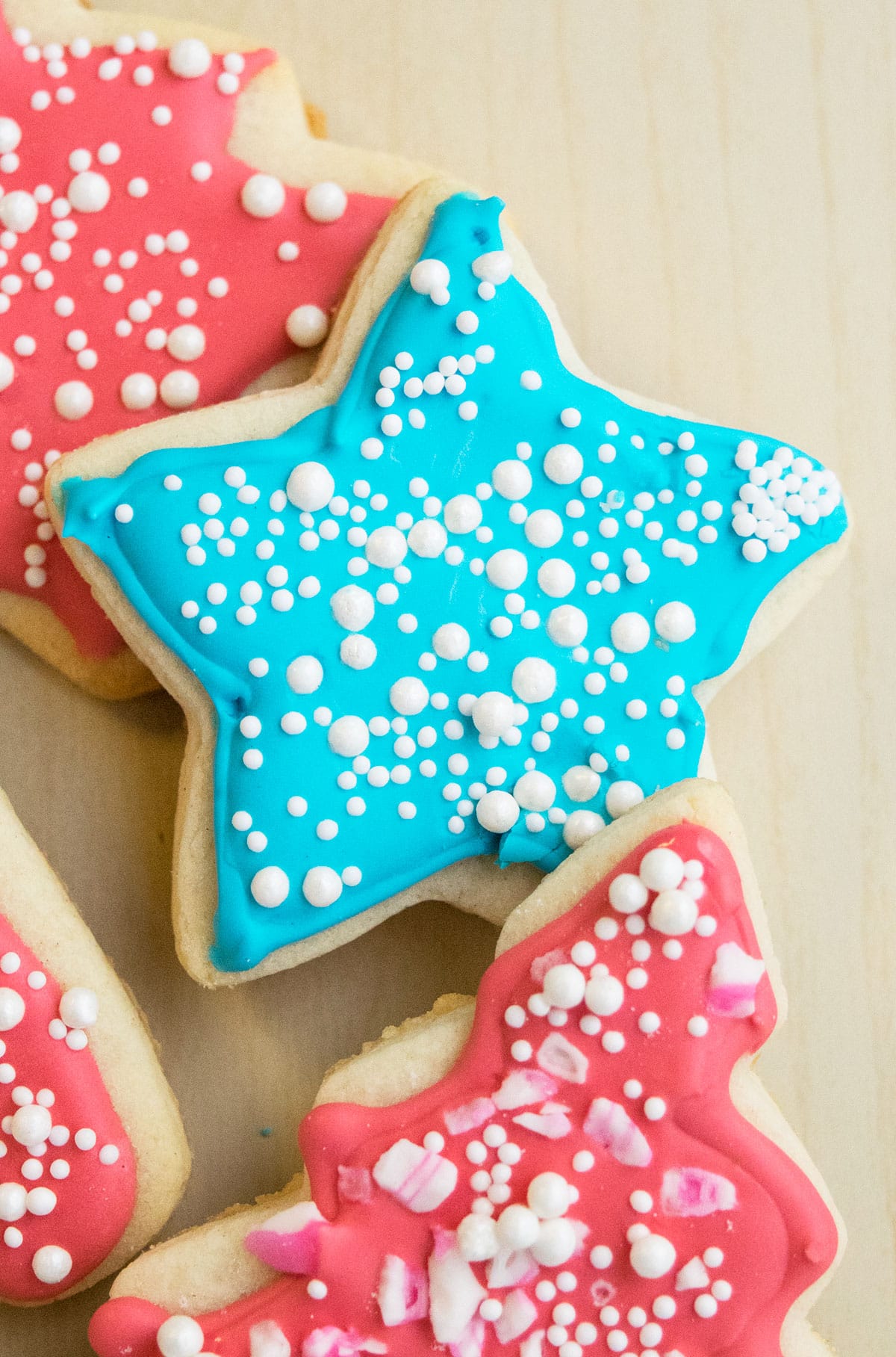 Decorated cut out star cookie on wood background. 