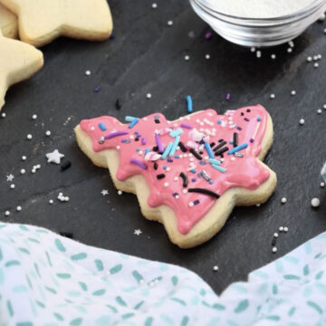 Sprinkles tossed on top of iced cookie. 