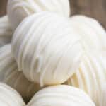 Stack of Easy Vanilla White Chocolate Truffles With Condensed Milk or Heavy Cream on Wood Background.