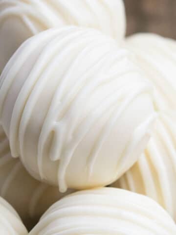Stack of Easy Vanilla White Chocolate Truffles With Condensed Milk or Heavy Cream on Wood Background.