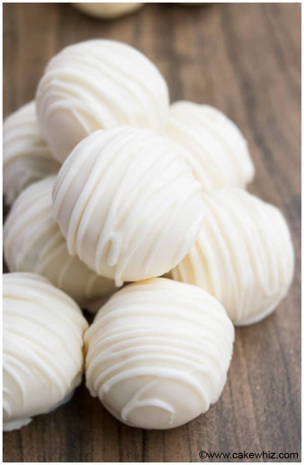 Stack of Homemade White Chocolate Truffles on Wood Background. 