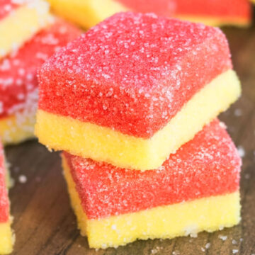 Stack of Jello Marshmallow Candy Slices on Wood Background.