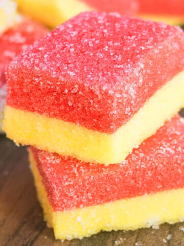 Stack of Jello Marshmallow Candy Slices on Wood Background.