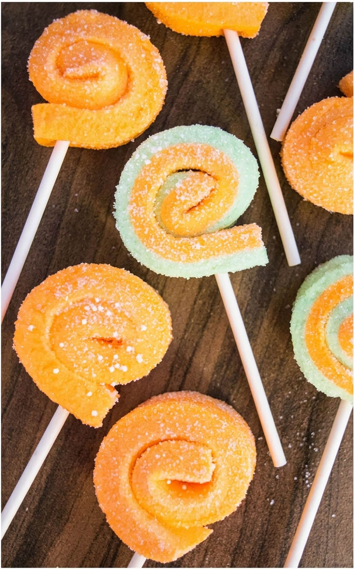 Orange and Green Jello Pinwheels or Roll Ups on Wood Background. 