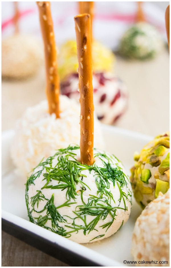 Mini Cheese Ball Covered in Fresh Dill on White Tray. 