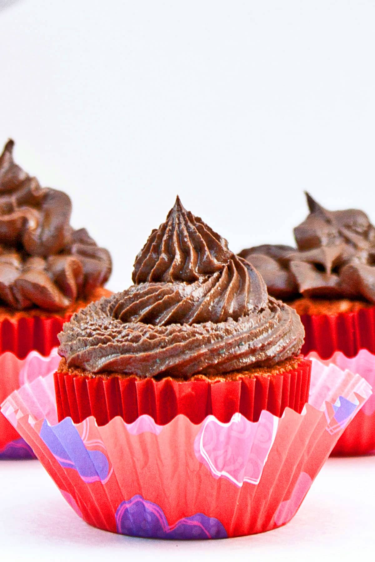 Easy Cooked Flour Chocolate Ermine Frosting Piped on Top of Cupcake With White Background. 