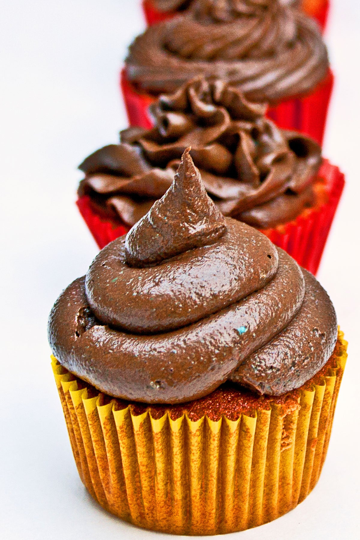 Closeup Shot of Swirl of Icing on a Cupcake With White Background. 