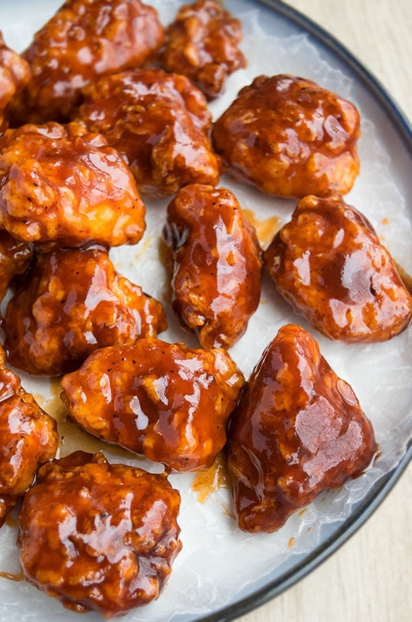 Easy Sticky Honey BBQ Chicken Bites on White Dish. 