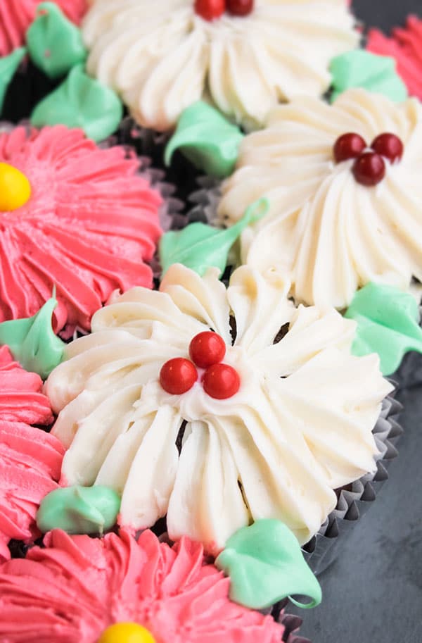 Closeup Shot of White Buttercream Flower Cupcake on Black Background