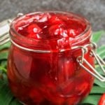 Easy Cherry Pie Filling From Scratch in Glass Jar on Green Leaf.