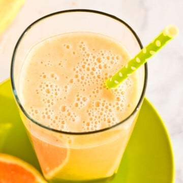 Easy Mango Smoothie With Bananas and Oranges in Glass Cup.