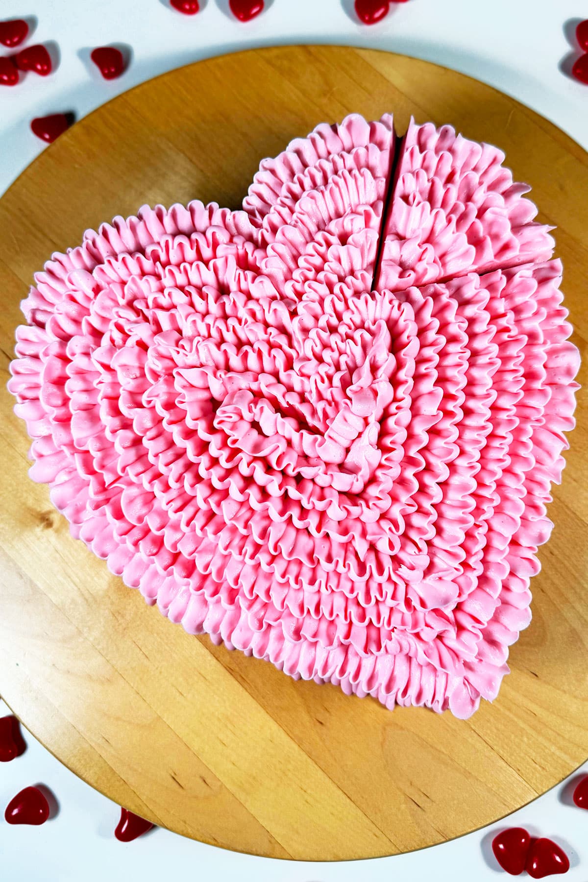 Decorated Pink Heart Cake on Wood Dish.