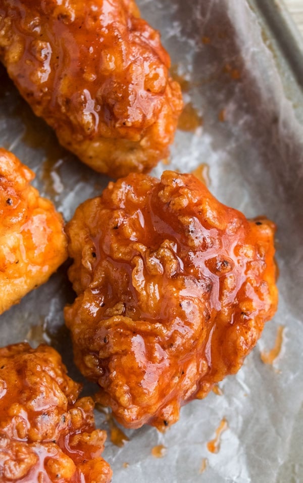 Closeup Shot of Spicy Chicken Bites on Sheet of Wax Paper. 