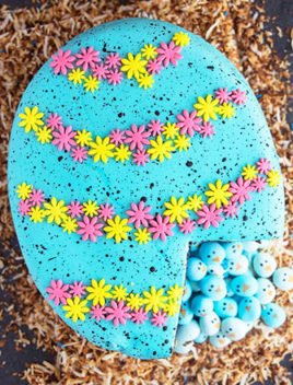 Easy Pinata Cake (Easter Robin Egg Cake) With One Slice Removed on Rustic Background