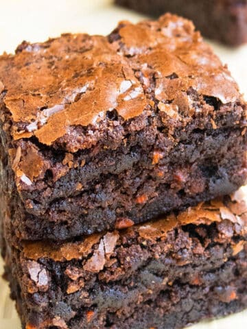 Stack of Easy Chocolate Carrot Brownies (Carrot Cake Brownies) With Box Mix on Wood Background.