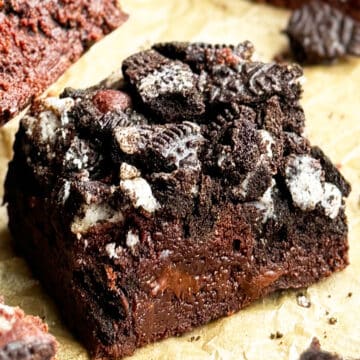 Slice of Easy Fudgy Chocolate Oreo Brownies on Brown Parchment Paper.