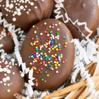 Easy Homemade Peanut Butter Eggs With Sprinkles on Fake Nest.