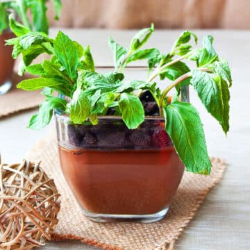 Easy Mini Chocolate Pudding Pots or Dirt Pudding Cups With Oreos and Fresh Mint on Rustic Brown Background.